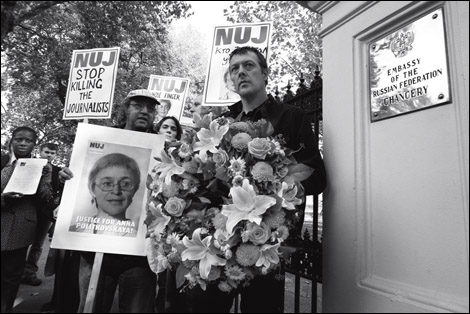 NUJ general secretary Jeremy Dear holds a wreath in memory of Anna Politkovskaya outside the Russian embassy in London.